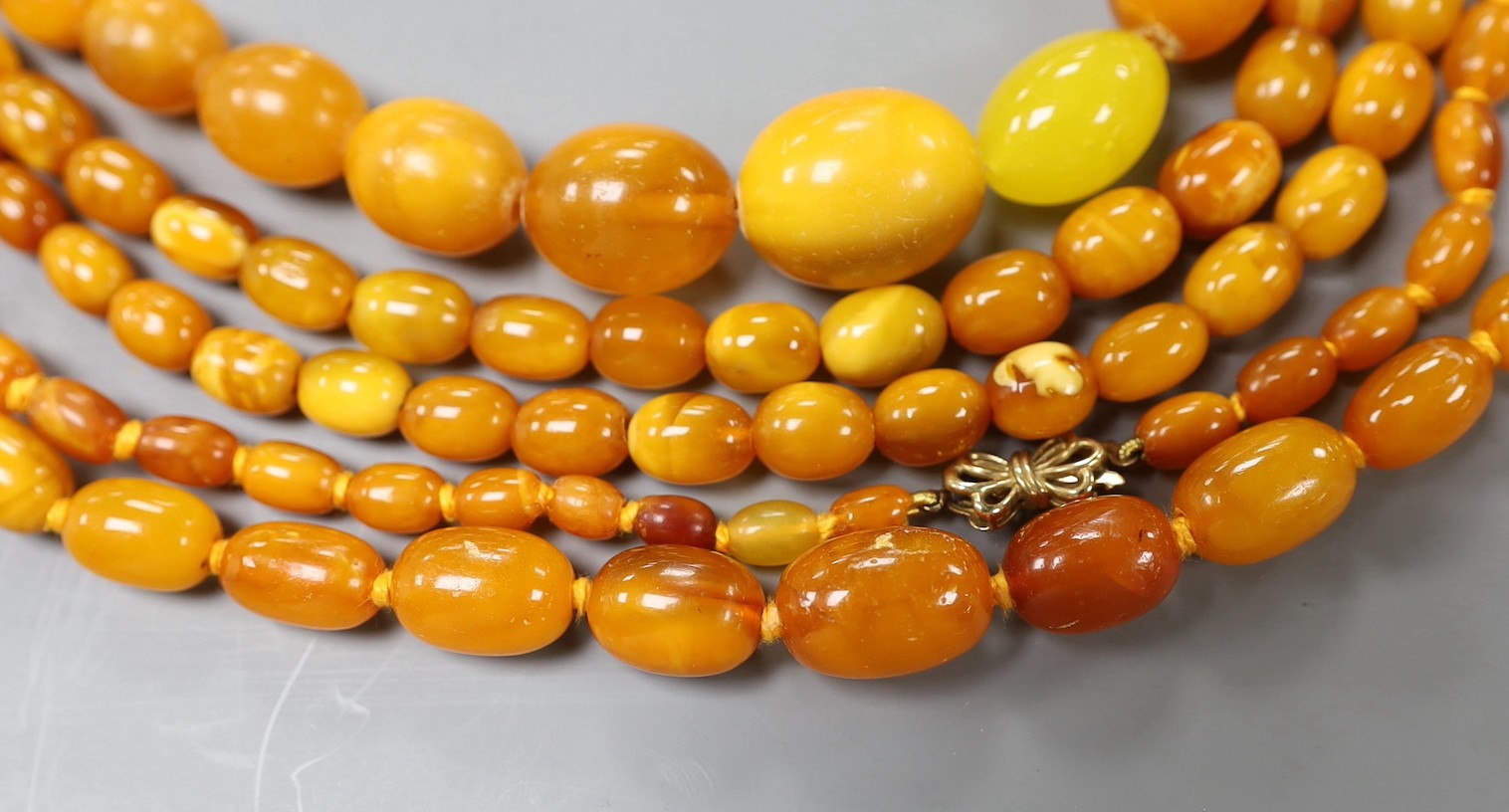 Three assorted amber bead necklaces, longest 112cm, gross weight 115 grams.